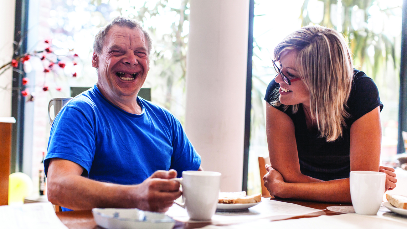 Adult Man Portrait with a Down Syndrome in a Daycare Center